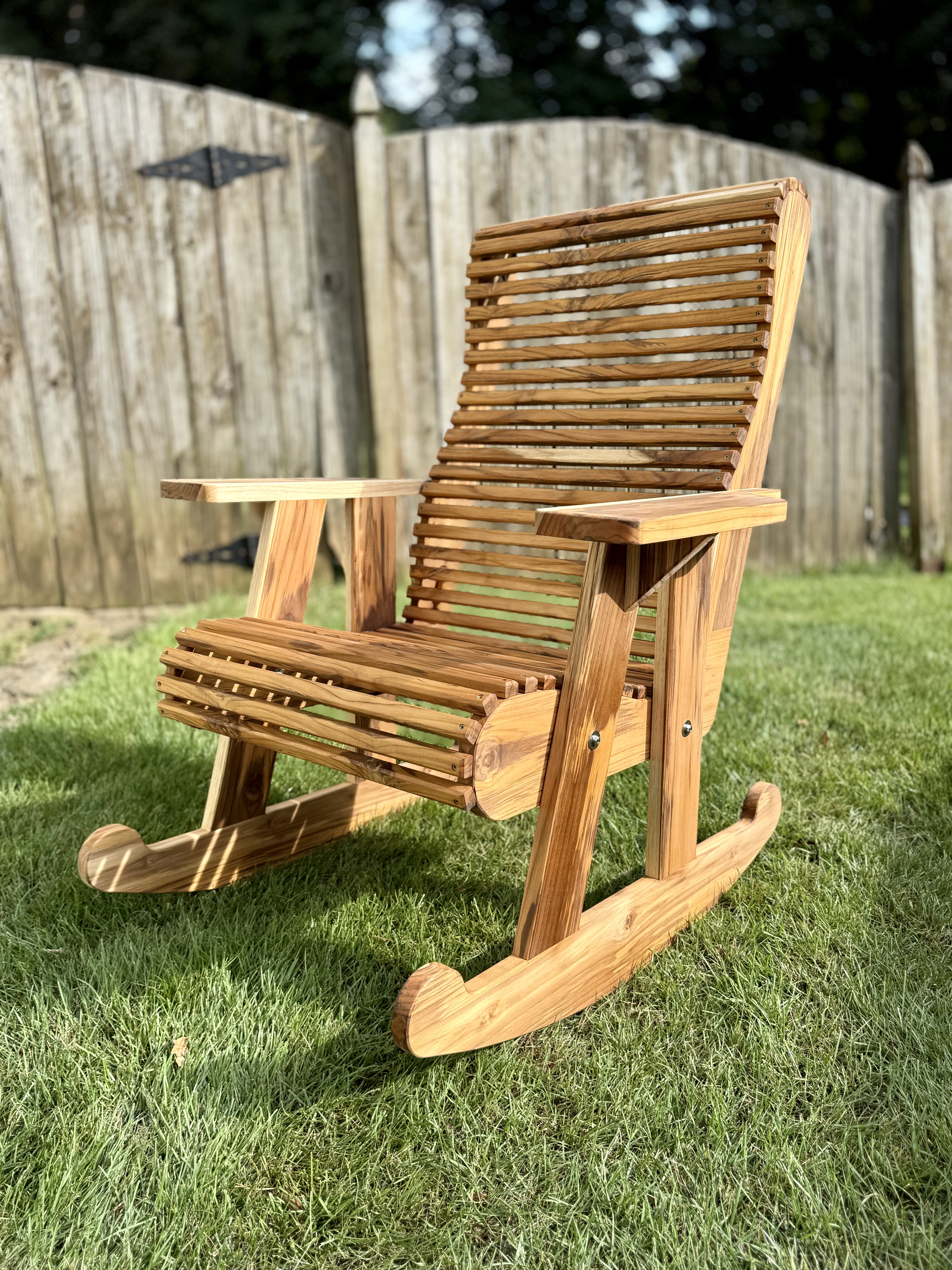 Swamp teak rocking chair on grass